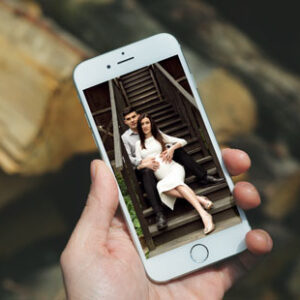 man-holding-i-phone-12-mock-up